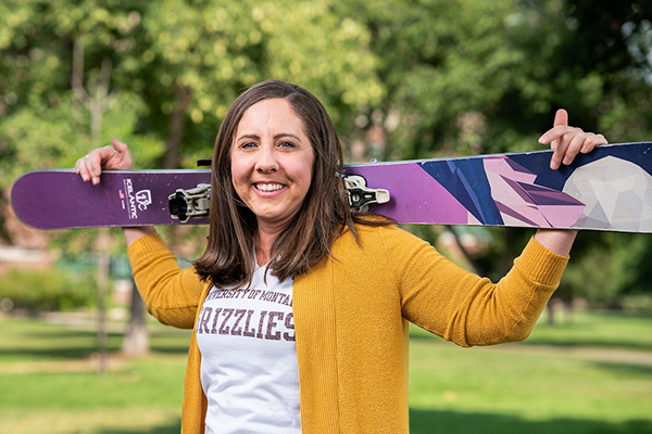 Julie Ann Williams holds her skis across her shoulders and smiles