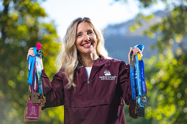 Michelle holds up her race medals